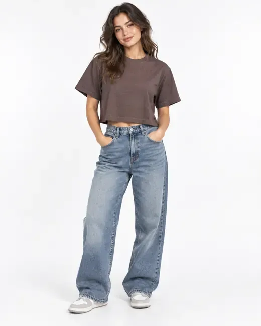 A model in a brown cropped tee and wide leg jeans